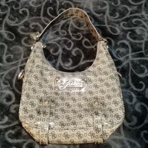 Beige in color Guess hand bag